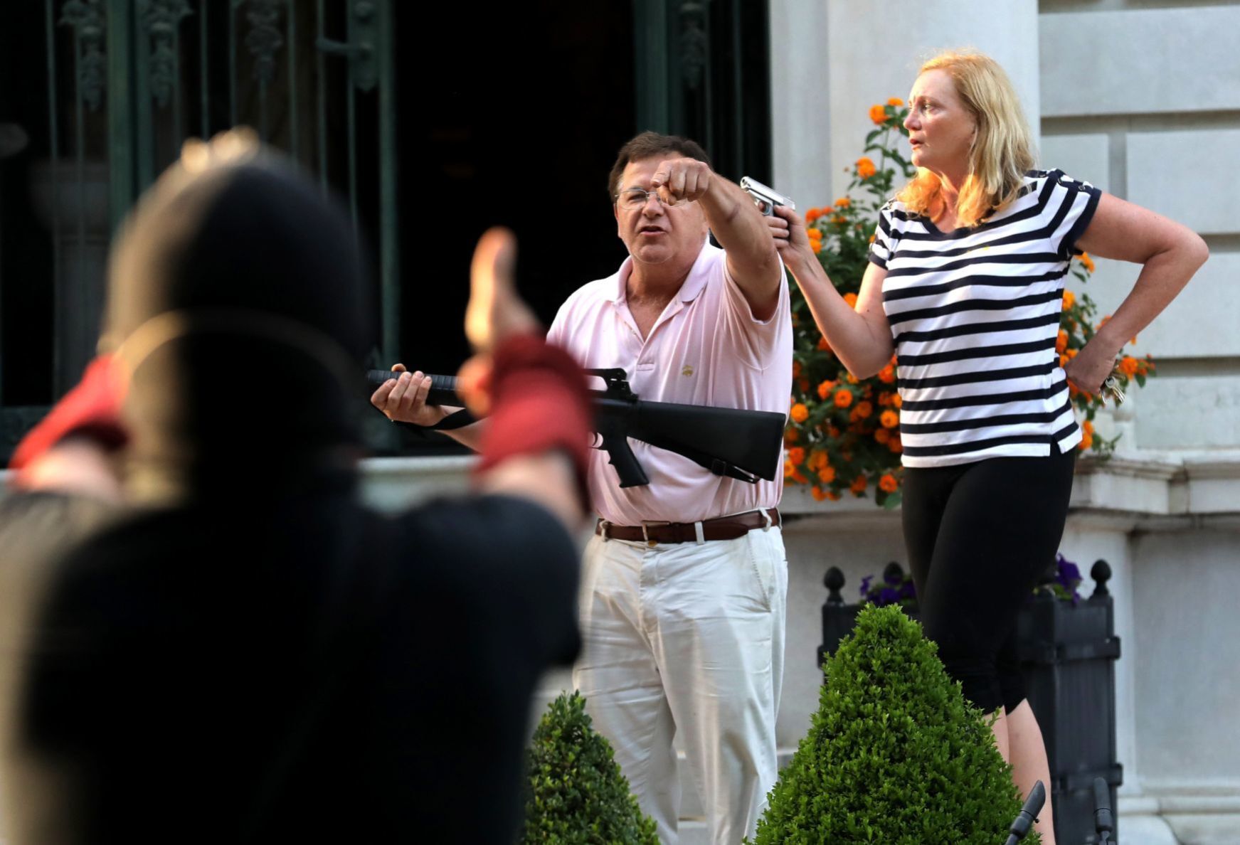 CWE couple display guns during protest